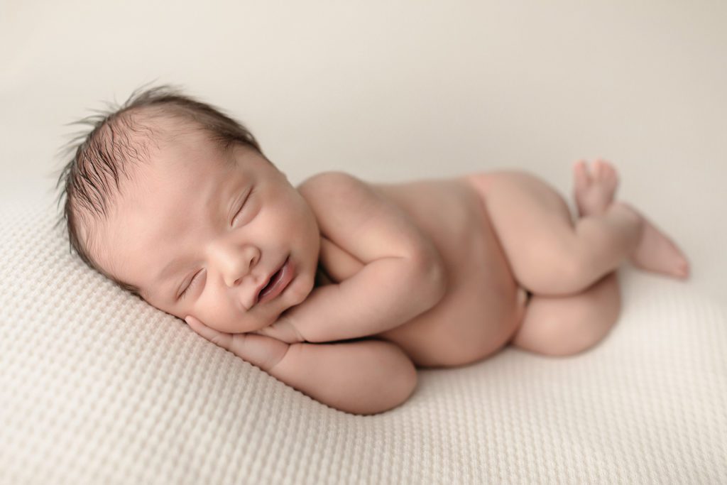Smiling baby boy newborn photo shoot